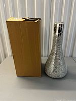 Vase standing beside its cardboard box