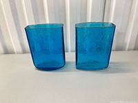 Front view of both blue square vases showing color, texture and shape