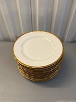 Stack of gold-rim salad plates