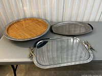 All three stainless steel trays displayed on table