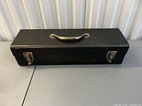 Closed black toolbox showing handle and latches