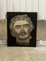 Front view of charcoal portrait on board