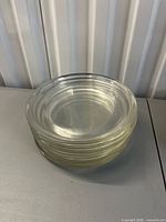 Stack of six clear glass plates