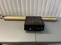 Projector and retracted screen on table