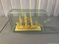 Front view showing sailing ship inside clear bottle