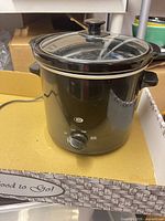 Full view of black 2-quart slow cooker with lid in place