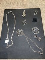 Group shot showing all jewelry pieces laid out on black background
