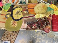 Assorted placemats, runners, mats and fabrics spread on table