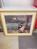 Full view of framed print leaning against surface