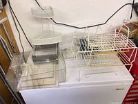 All items grouped on freezer top showing wire racks, plastic bins, corner shelf