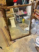 Full view of rectangular mirror showing ornate gold-tone frame and glass