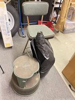 Shop chair, step stool and plastic sheeting grouped together