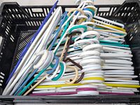 Crate filled with plastic hangers showing assorted colors and quantities