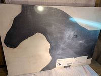 Front view of factory-wrapped IKEA PJÄTTERYD horse silhouette canvas