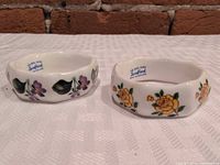 Both Sandford bone china napkin rings, floral motifs visible