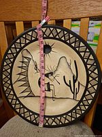 Front view with tape measure showing diameter and design details