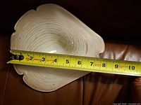 Top view of swirl glass dish with tape measure showing size