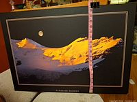 Front of poster showing image, caption and size reference with tape
