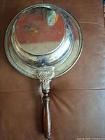 Top view of silver-plated bowl showing handle and ornate rim