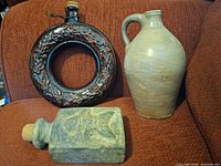 Group shot of ring flask, jug, and fish motif bottle