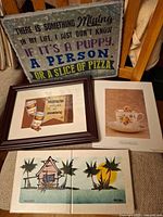 Front view showing galvanized sign, framed coffee print, packaged Anne Geddes board, two Key West tiles