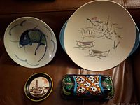 Fronts of four ceramic items