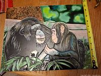 Front view of large ceramic tile showing primate scene and measuring tape indicating height ~12 in