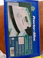Retail box front showing image of Proctor-Silex steam/dry iron and model number C1227