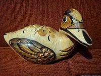 Left side view of ceramic duck showing painted feather detail
