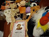 Group shot of all plush toys and crochet kit on chair