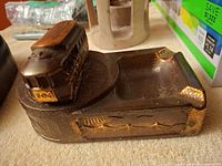 Oblique view of ashtray showing trolley figurine and bronze finish