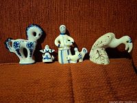 Front view of all four USSR porcelain figurines on sofa