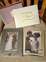 Front view of guest book, photo album, and two silver 5x7 frames