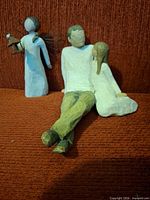 Front view showing all three figurines on red background