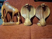 front view of giraffe figurine and two cobra figurines