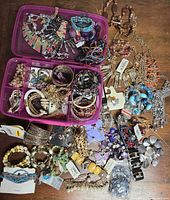 Overview of entire jewelry lot spread on table and organizer