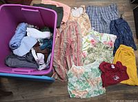 Overall lot showing tote and clothing spread out