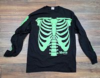 Front view showing glow-in-dark green ribcage graphic