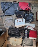 Group shot of all twelve handbags arranged on floor