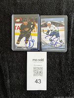 Both autographed Brock Boeser cards in sleeves