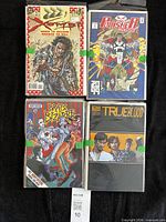 Four bagged comic books: X-O Manowar, Punisher 2099, Brats Bizarre, True Blood