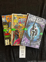 Stack of comic books bundled together showing front issue covers, lot tag visible