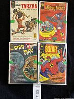 Four primary comics laid out showing titles and condition