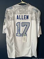 Full rear view of jersey on hanger showing name, number and digital camo shoulders