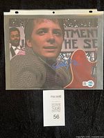 Full view of signed 8x10 photo in sleeve with COA sticker visible