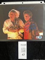 Front view of signed 8x10 photo in sleeve, both signatures visible