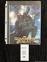 Front view of signed 8x10 Yondu photo in sleeve with maxsold tag