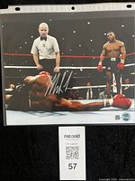 Full image of signed photograph showing hologram sticker