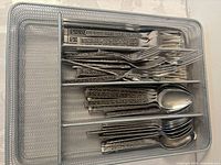 Flatware set in mesh organizer drawer