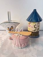 Group shot of sugar pot with spreader, canister, and pitcher